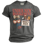 Dark gray t-shirt with "Under New Management", "Mike's Bach", "LA, CA", and gambling graphics.