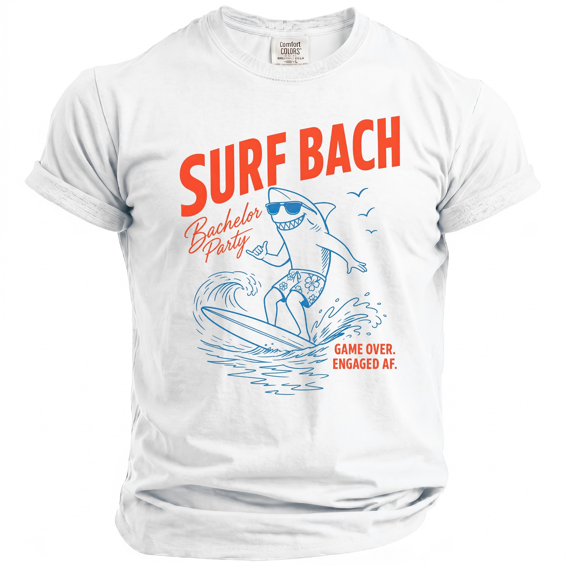 White t-shirt with orange text "SURF BACH", a surfing shark, and "GAME OVER. ENGAGED AF."