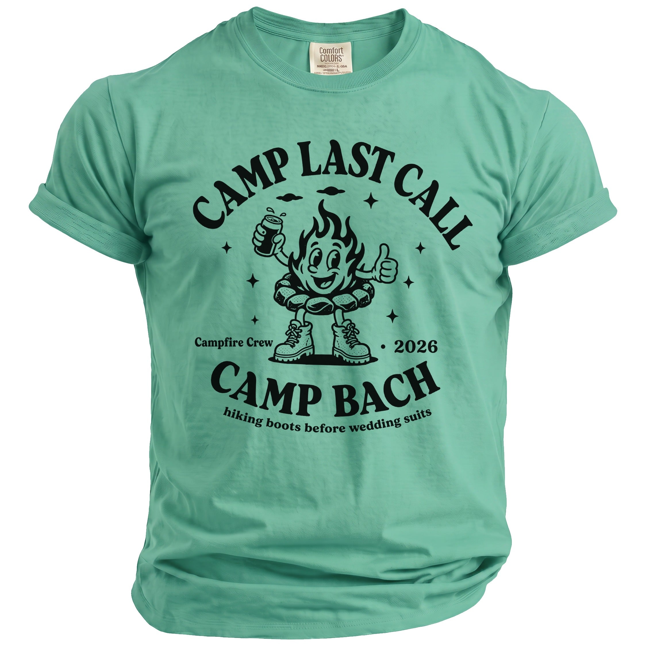 A mint green t-shirt with black text reading Camp Last Call Camp Bach and a campfire cartoon graphic.