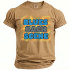 Tan t-shirt with "BLUES BACH SCENE" text in blue and gray bubbly font.