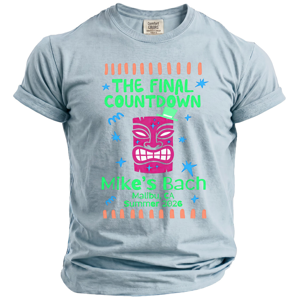 Light blue t-shirt with pink tiki mask, "The Final Countdown", "Mike's Bach", and location/date text.