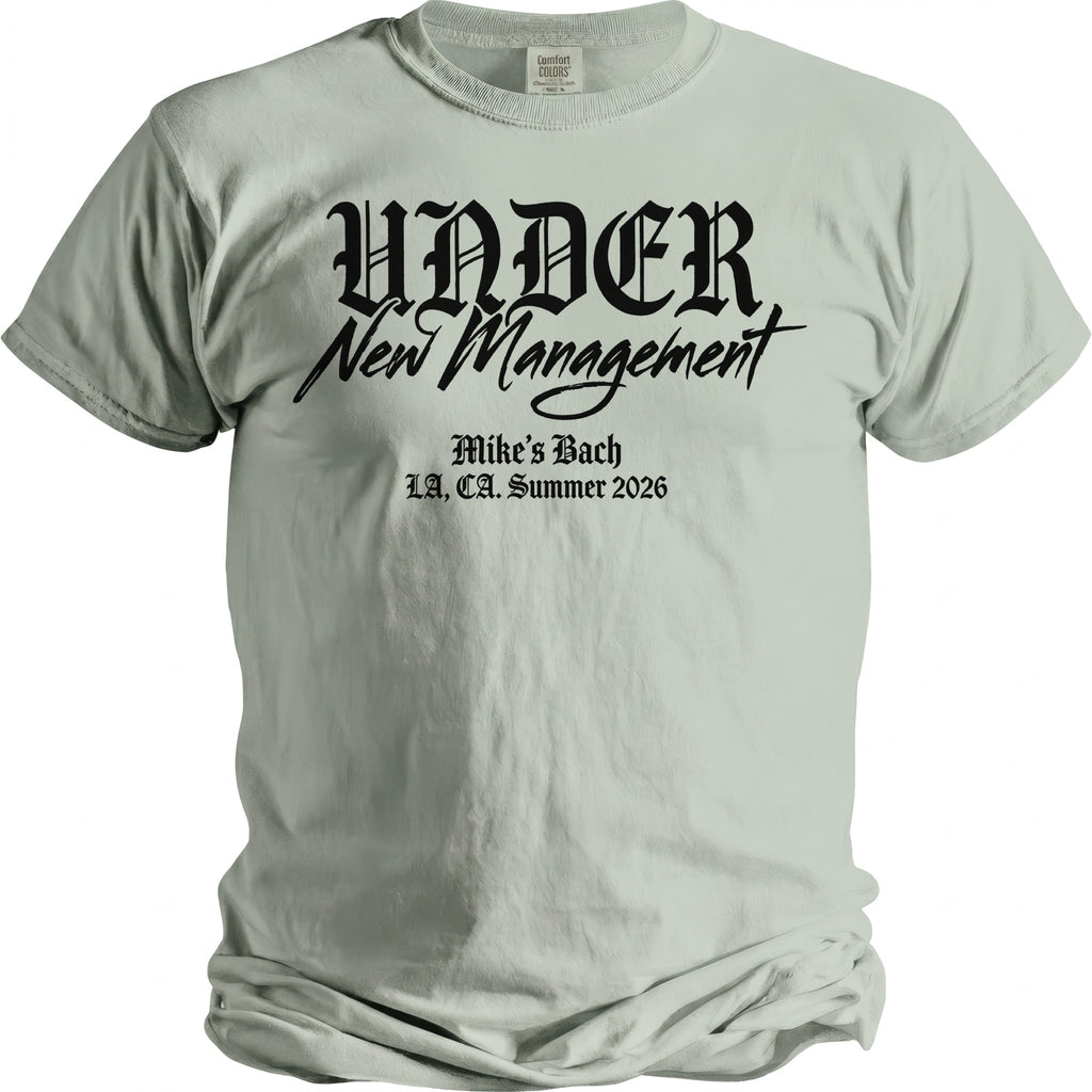 Light green t-shirt with black gothic text "UNDER New Management" and "Mike's Bach LA, CA. Summer 2026".