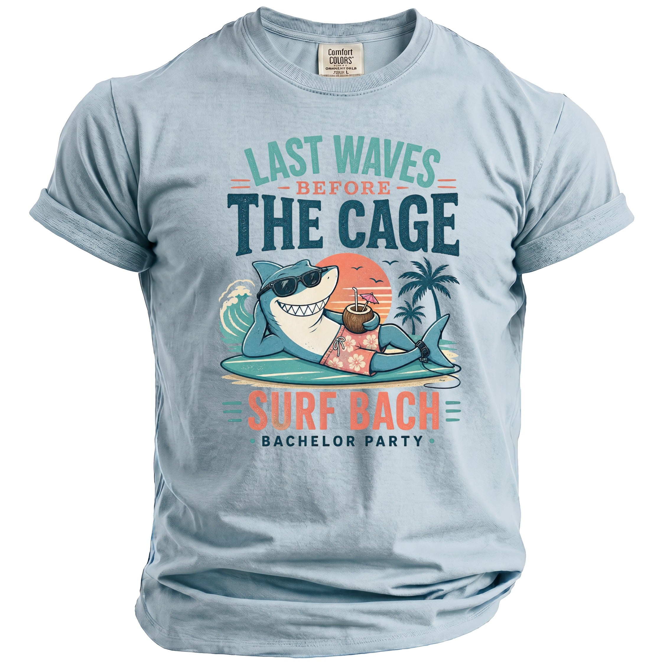 Light blue t-shirt with "Last Waves Before The Cage Surf Bach Bachelor Party" text and shark graphic.