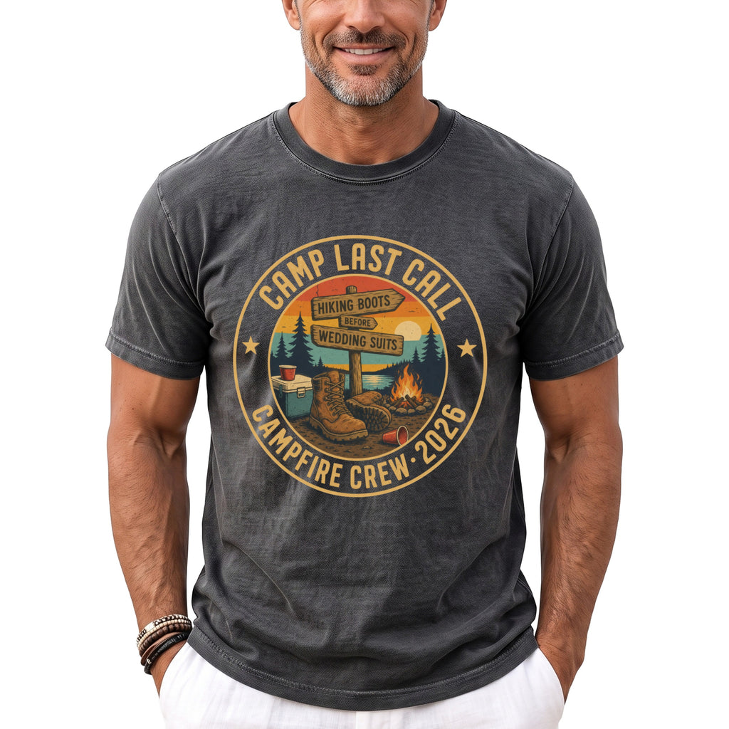 Camp Last Call campfire crew 2026 graphic on charcoal t-shirt featuring hiking boots and camping scene.