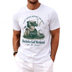 White t-shirt with a dragon golfer graphic and text: "Last swing before the ring. Bachelor Golf Weekend."