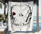 White tapestry with "Tangled in Forever" text, a rose, and spiderweb design.