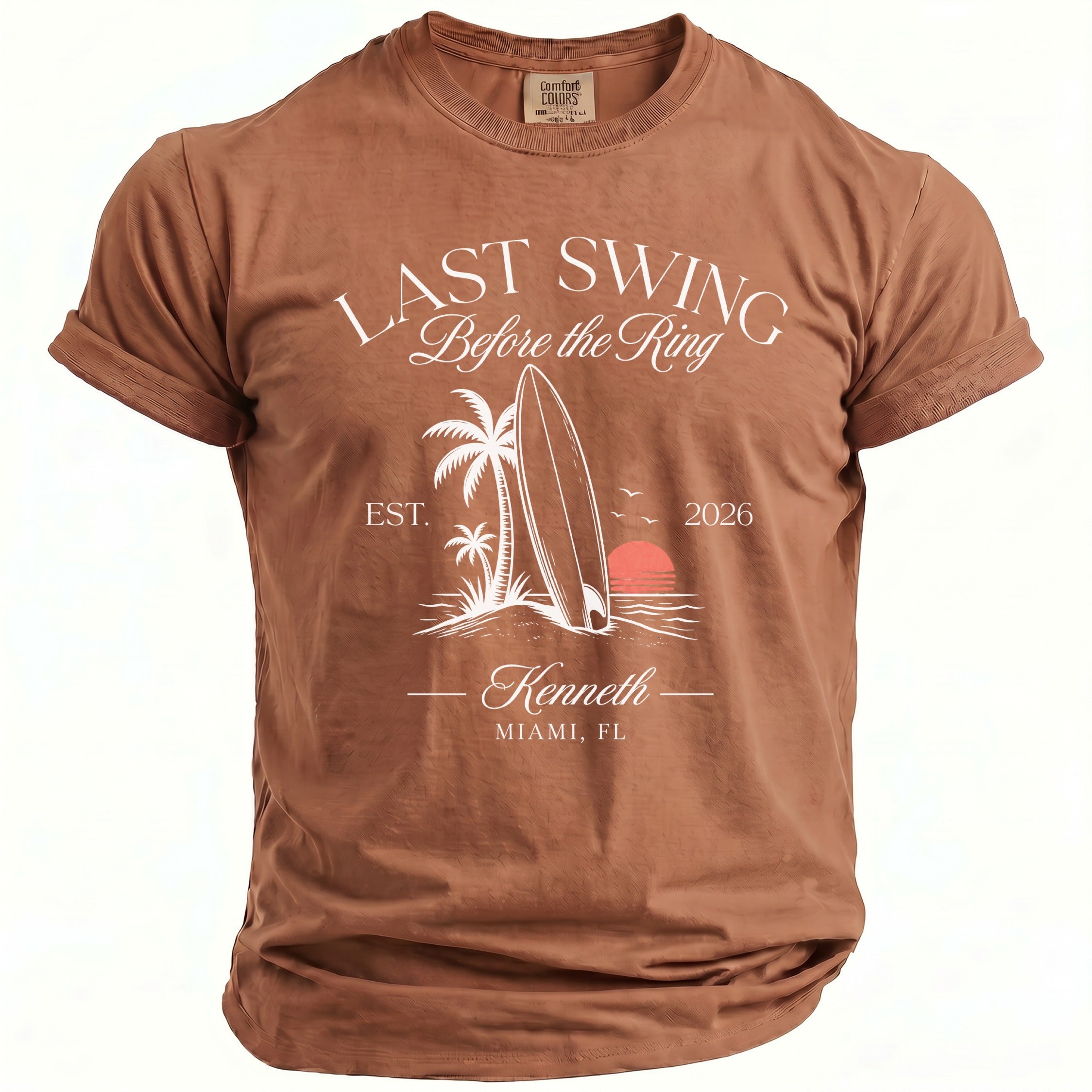 Brown t-shirt with "LAST SWING Before the Ring" graphic featuring a surfboard.
