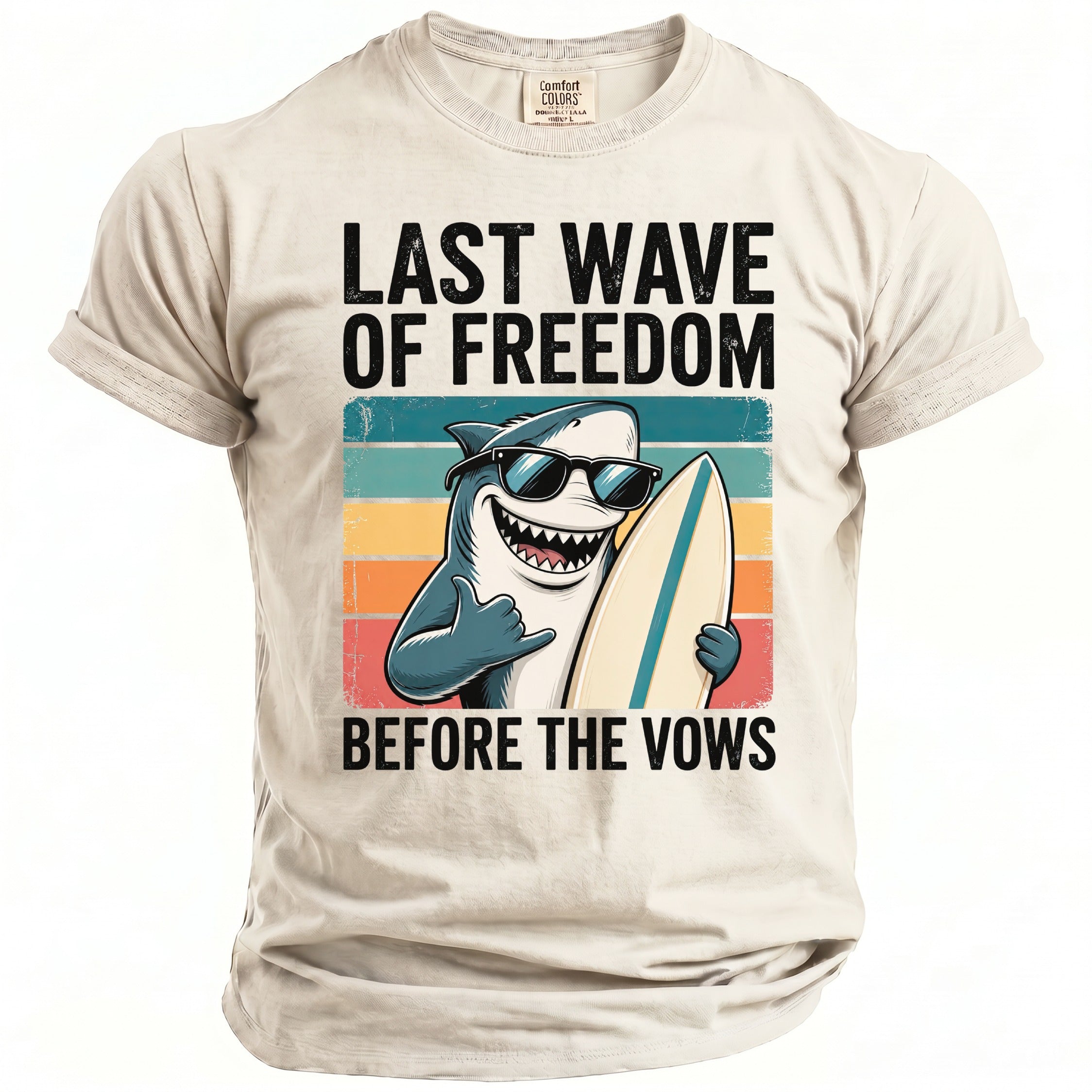 T-shirt graphic with a shark holding a surfboard and text "LAST WAVE OF FREEDOM BEFORE THE VOWS".