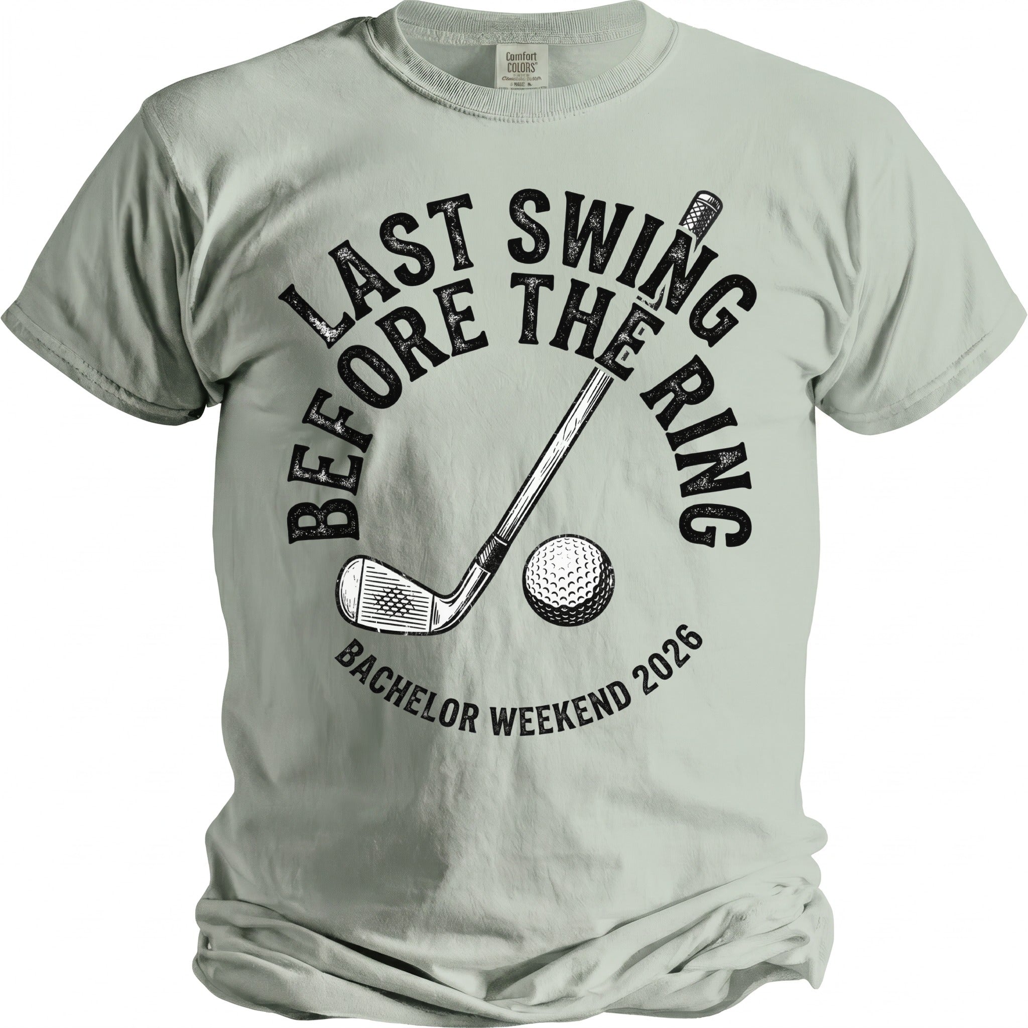 T-shirt with golf club, ball, and text "Last Swing Before The Ring Bachelor Weekend 2026".