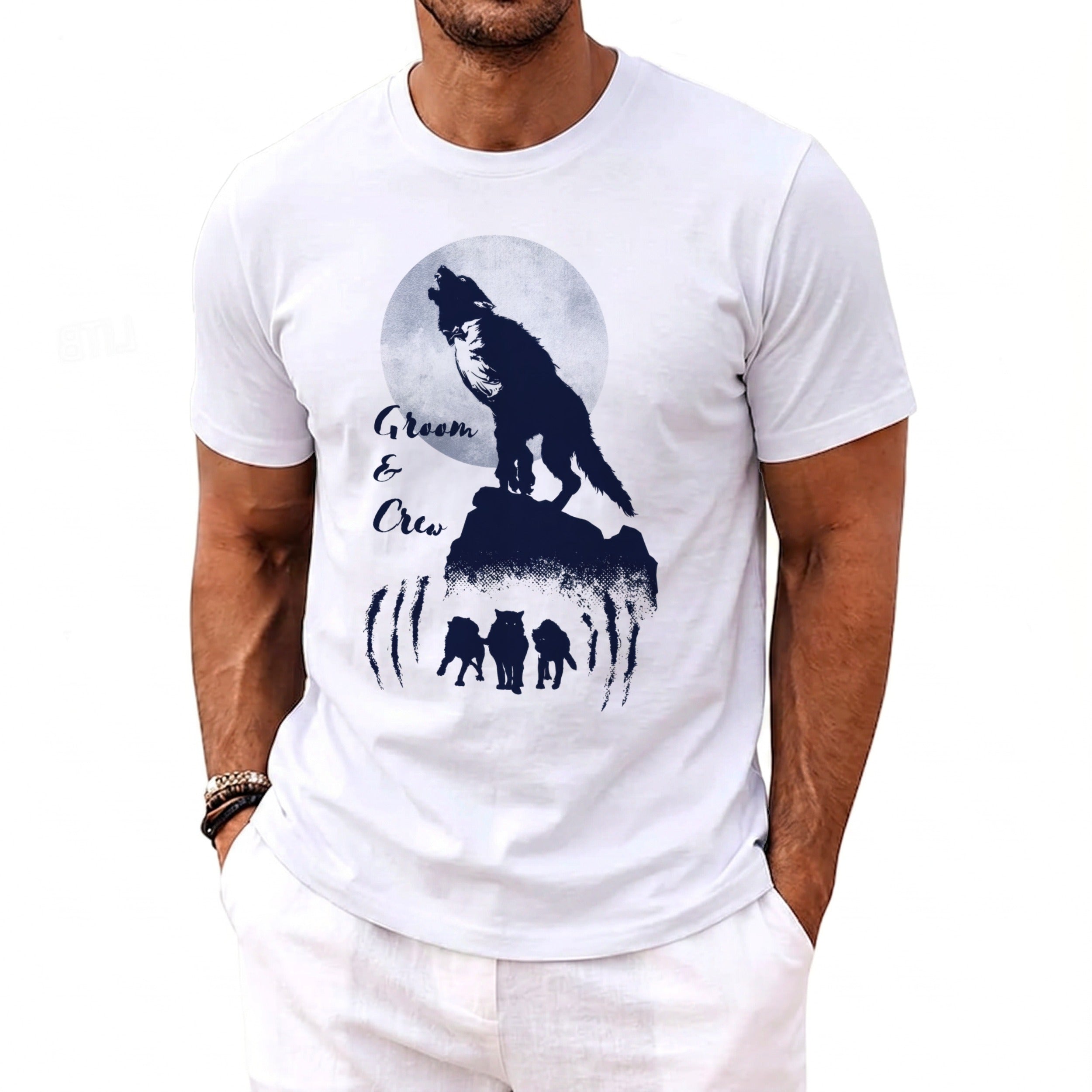White t-shirt with navy graphic of a wolf howling at moon and "Groom & Crew" text.