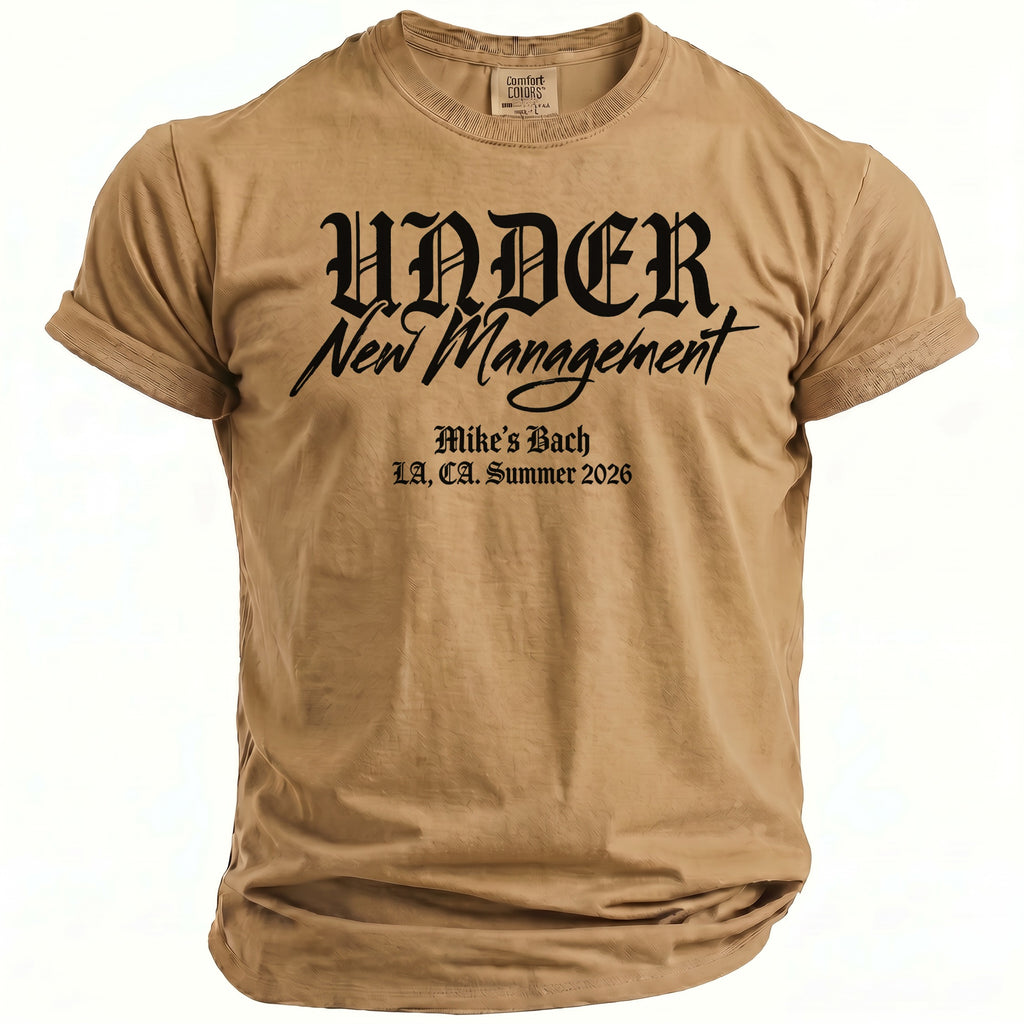 Tan t-shirt with black text "UNDER New Management" and "Mike's Bach, LA, CA. Summer 2026".