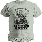 Light gray t-shirt with a dragon riding a motorcycle, saying "Last Ride Before The Ring".