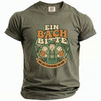Olive green t-shirt with graphic of man holding beer mugs, text reads "Ein Bach Bitte" and "One Last Stein Before the Ring".