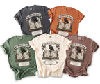 Five t-shirts in different colors featuring a raven on an open book with the text "Till Death, Our Forever."