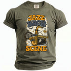 Olive green t-shirt with "Jazz Bach Scene" graphic featuring a saxophone, amplifier, and cocktail.