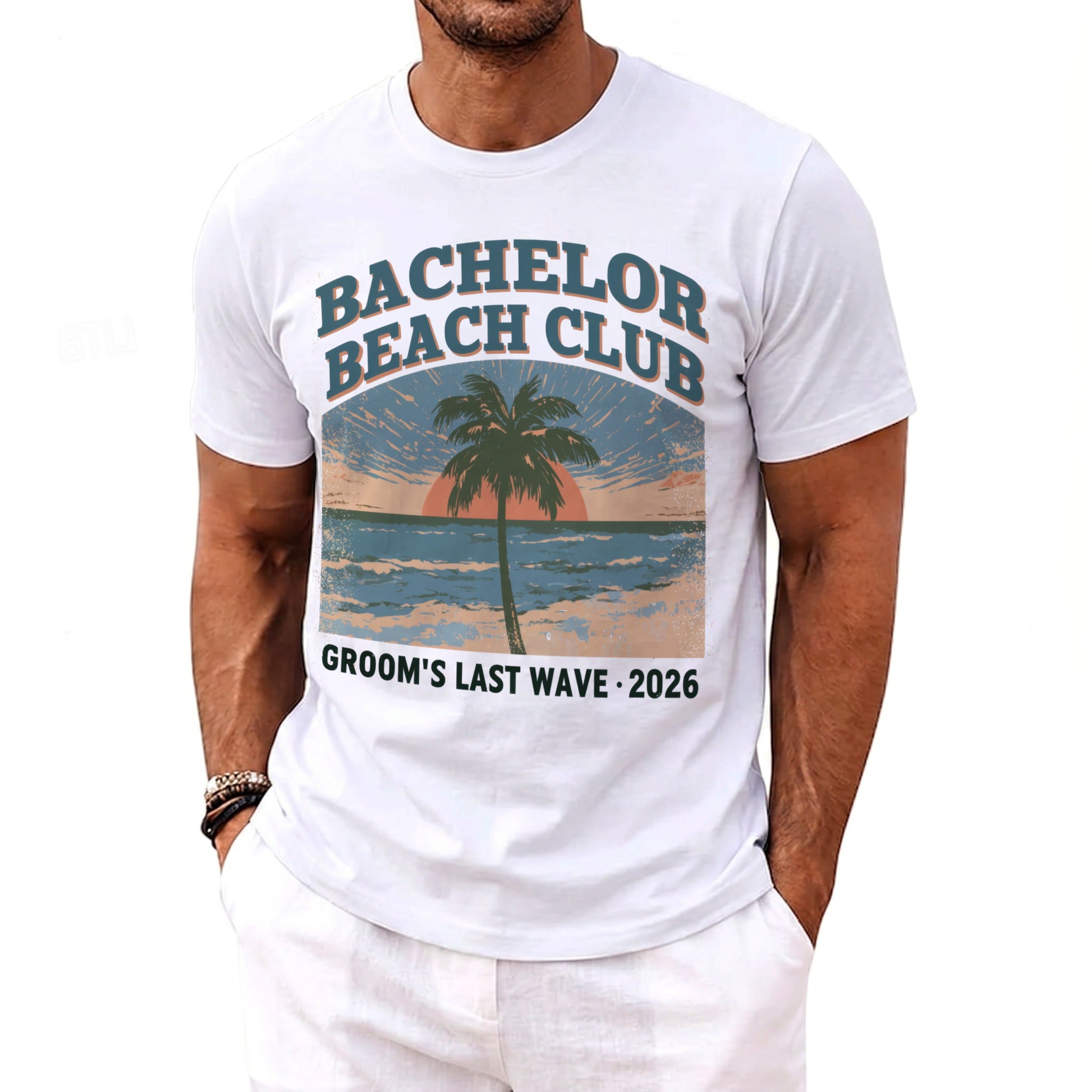 White t-shirt with "Bachelor Beach Club" and "Groom's Last Wave 2026" text and beach graphic.