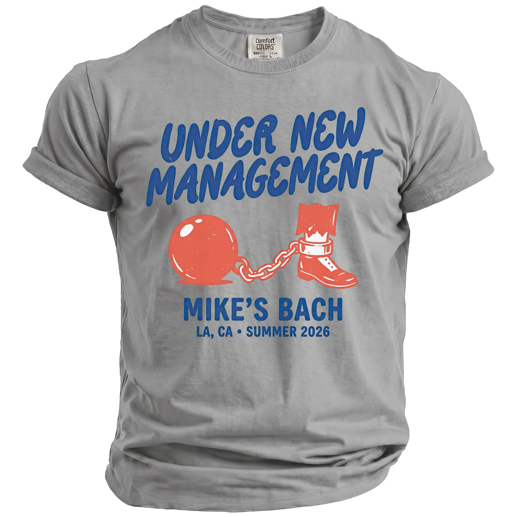 Grey t-shirt with "UNDER NEW MANAGEMENT MIKE'S BACH LA, CA SUMMER 2026" and ball and chain design.