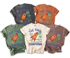 Five t-shirts in different colors featuring "The Final Countdown" text and spaceship graphic.