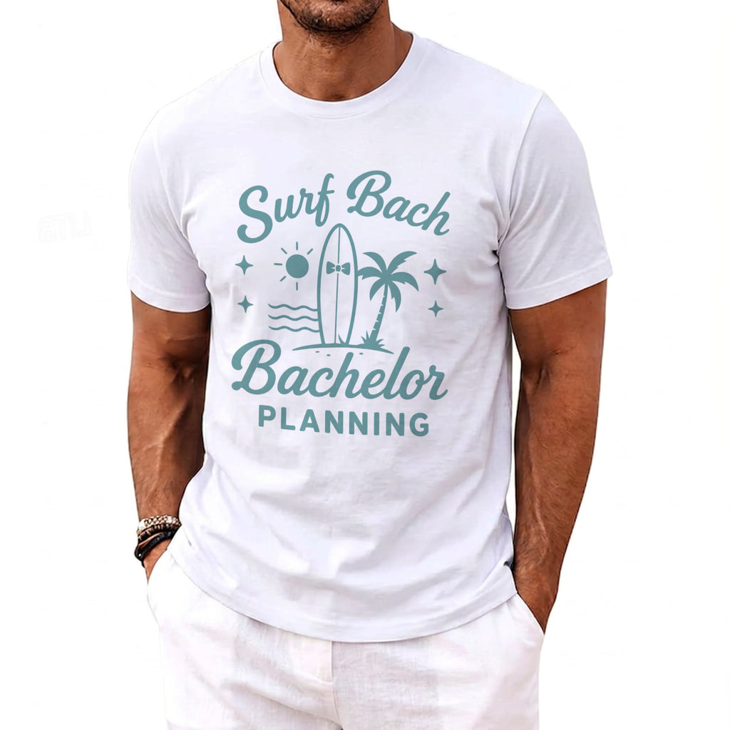 White t-shirt with turquoise graphic "Surf Bach Bachelor Planning" and beach scene.