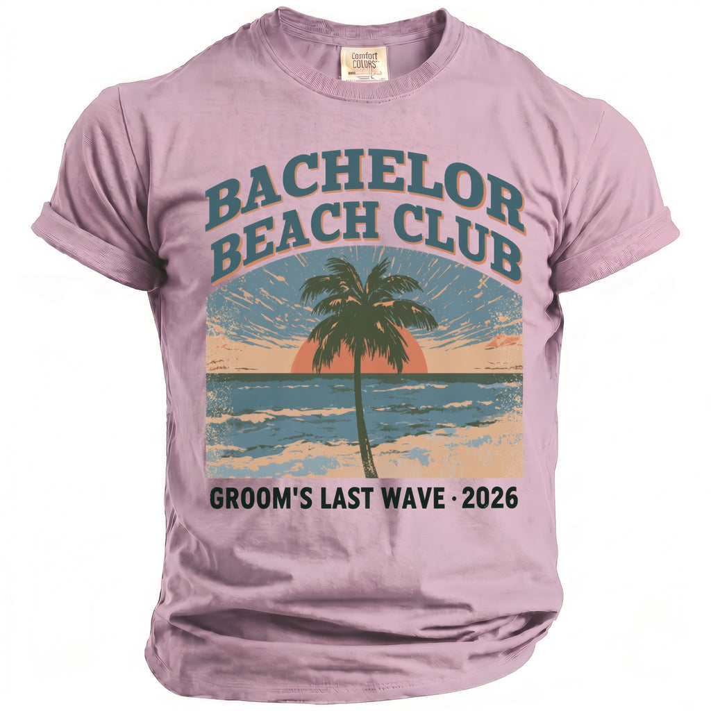 Pink t-shirt with "Bachelor Beach Club Groom's Last Wave 2026" text and beach graphic.