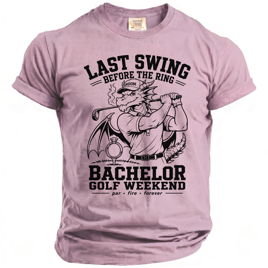 Pink t-shirt with a dragon golfer graphic and text "Last Swing Before the Ring" and "Bachelor Golf Weekend".