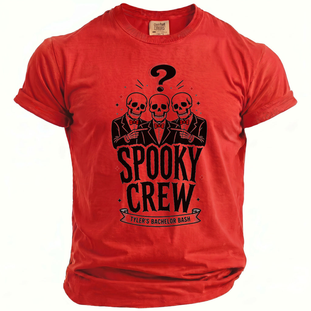 Red t-shirt with black graphic of three skulls, a question mark, and text "Spooky Crew Tyler's Bachelor Bash".
