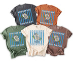 T-shirts with "Another One Bites The Dust" graphic and beer can design.