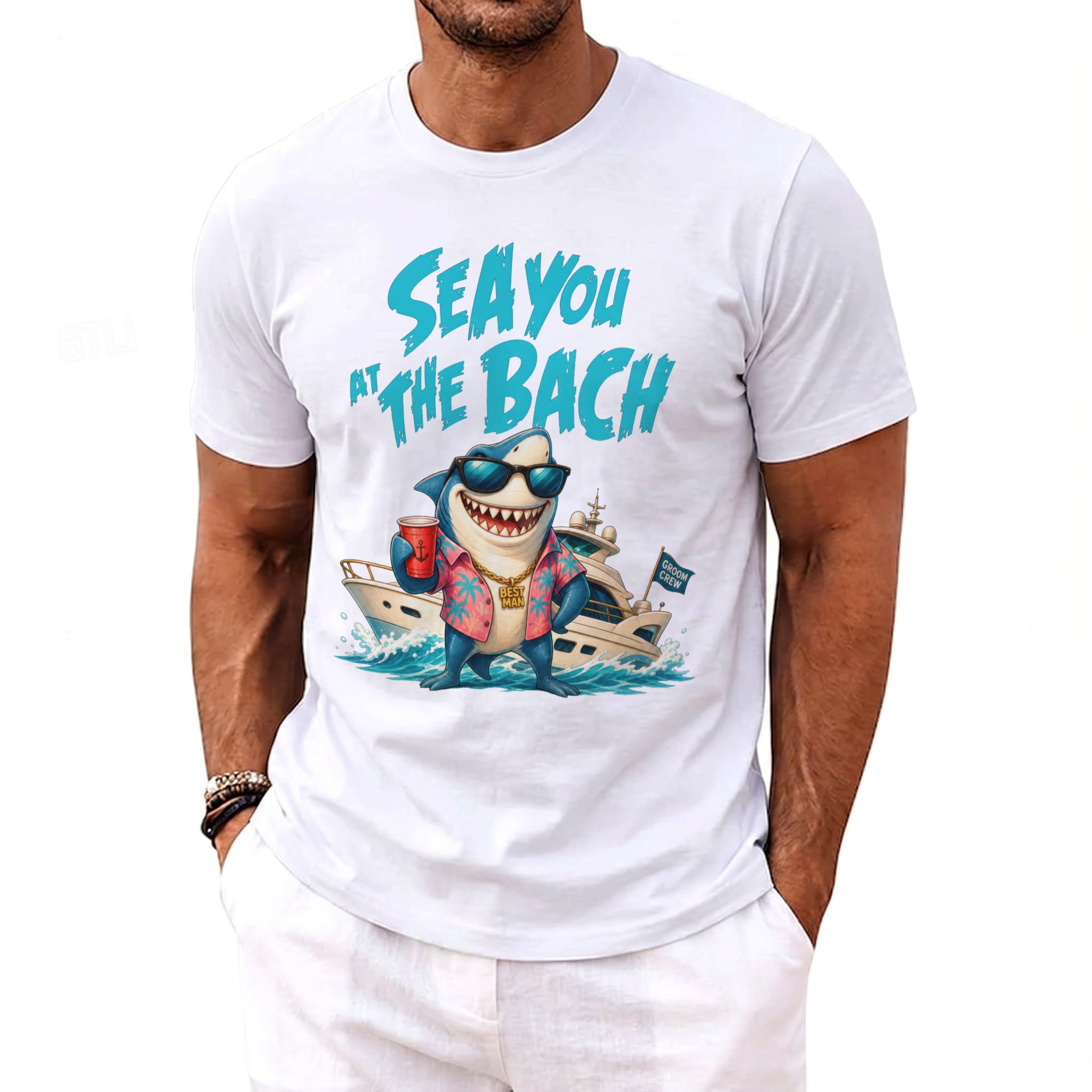 A white t-shirt featuring a cartoon shark in sunglasses and a floral shirt with a yacht graphic and text.
