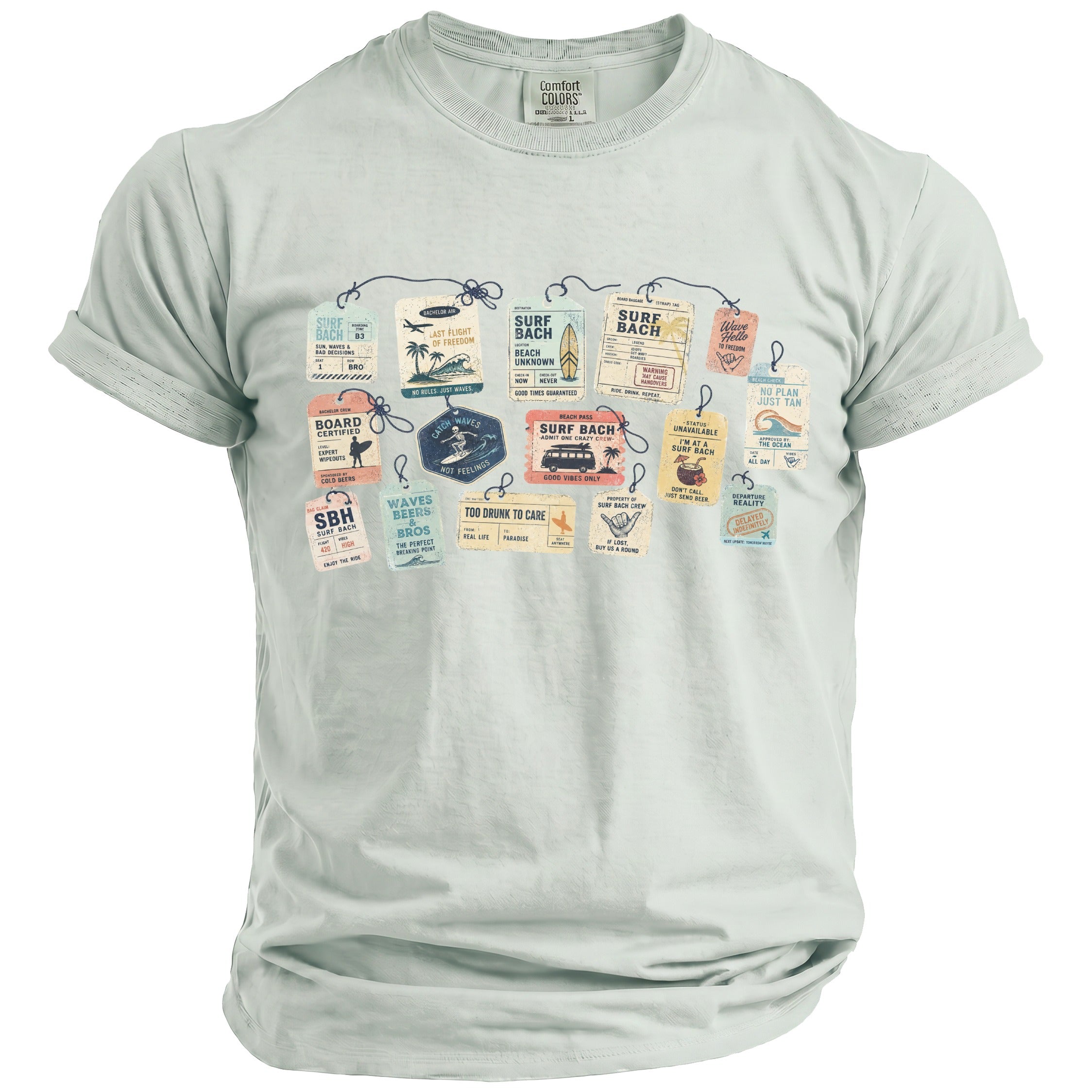 Pale green t-shirt with "Surf Bach" graphic featuring luggage tags and surf-themed text.