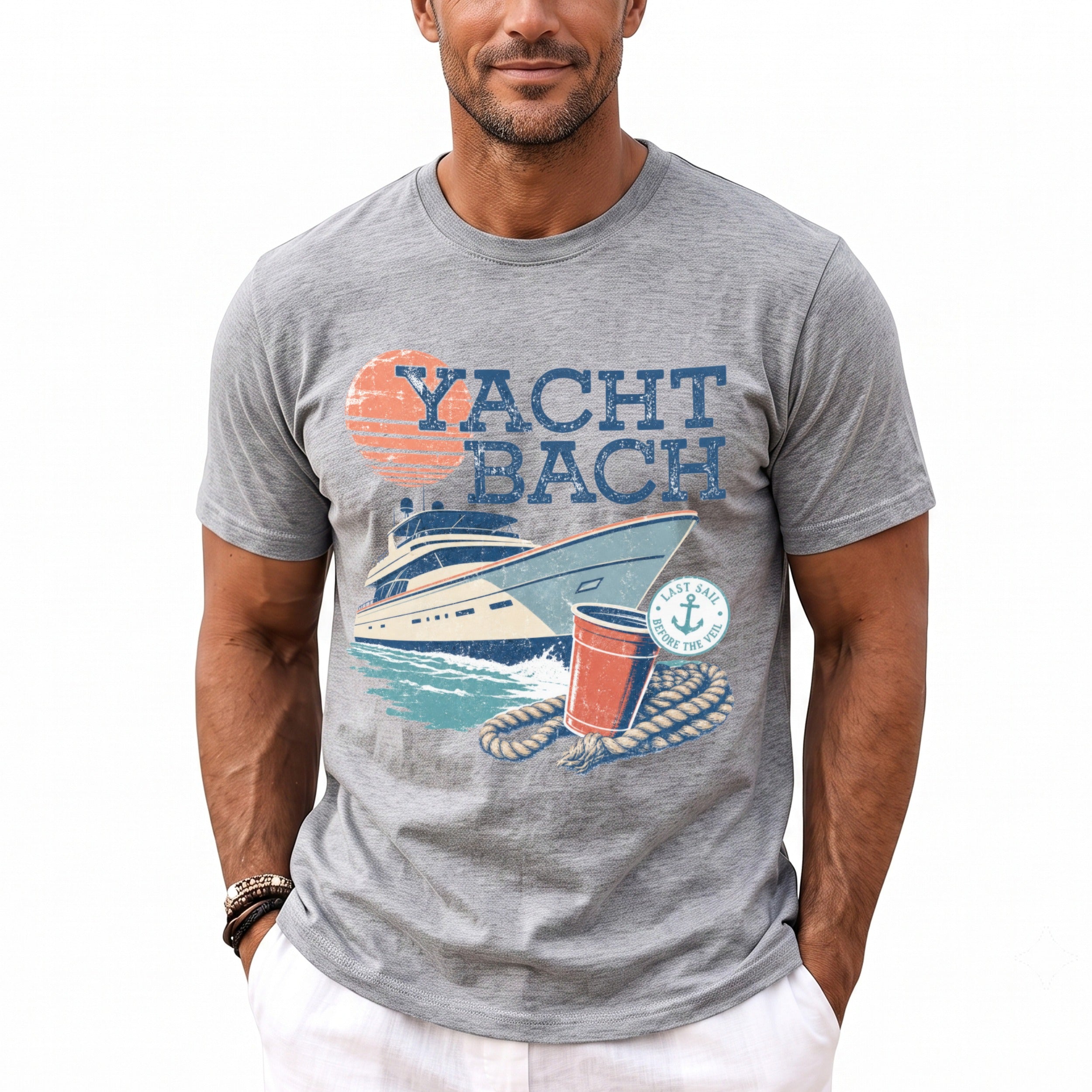 A man wears a gray crewneck t-shirt featuring a retro graphic of a yacht and text reading "Yacht Bach."