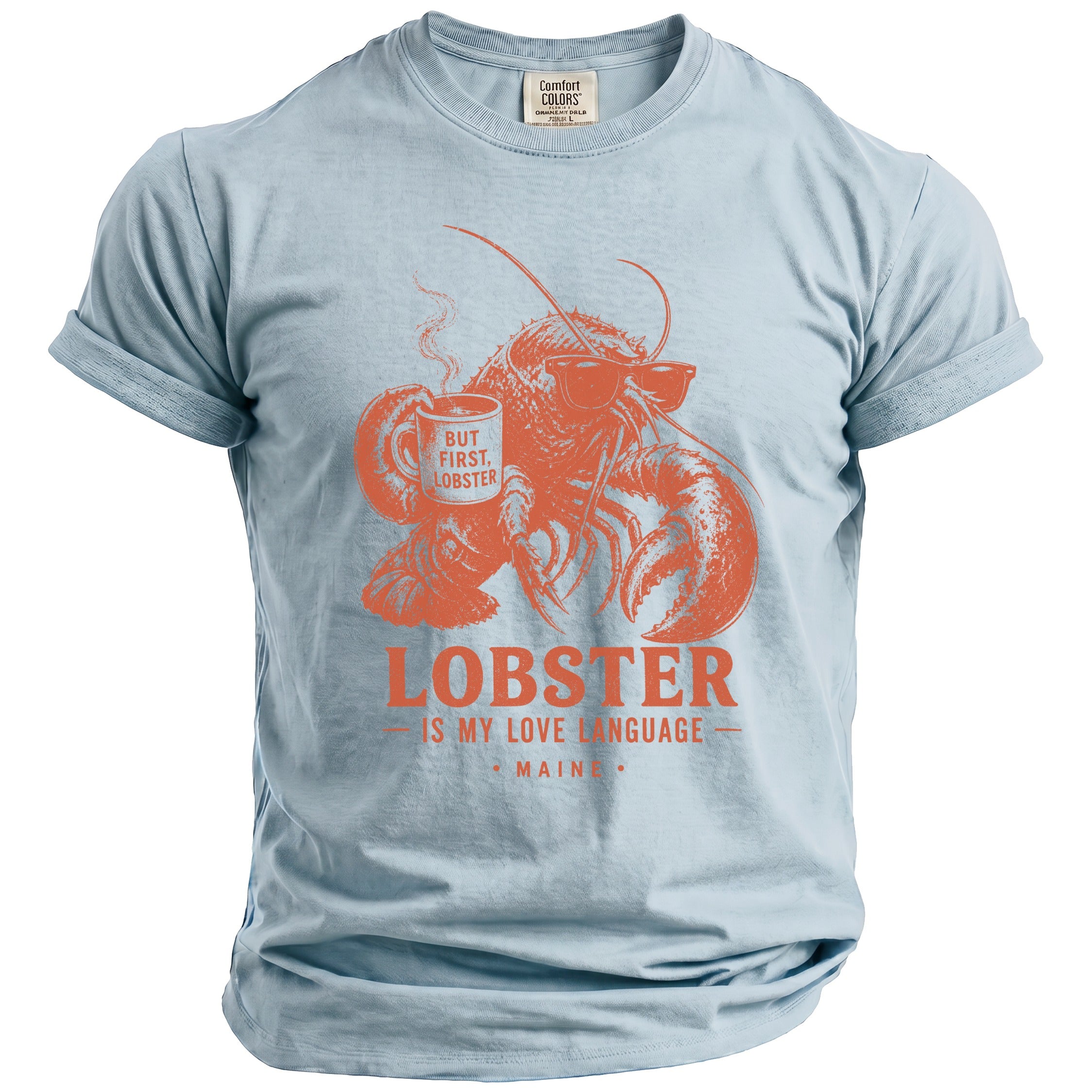 Light blue t-shirt with orange graphic of lobster holding coffee, text "But First, Lobster" and "Lobster Is My Love Language Maine".
