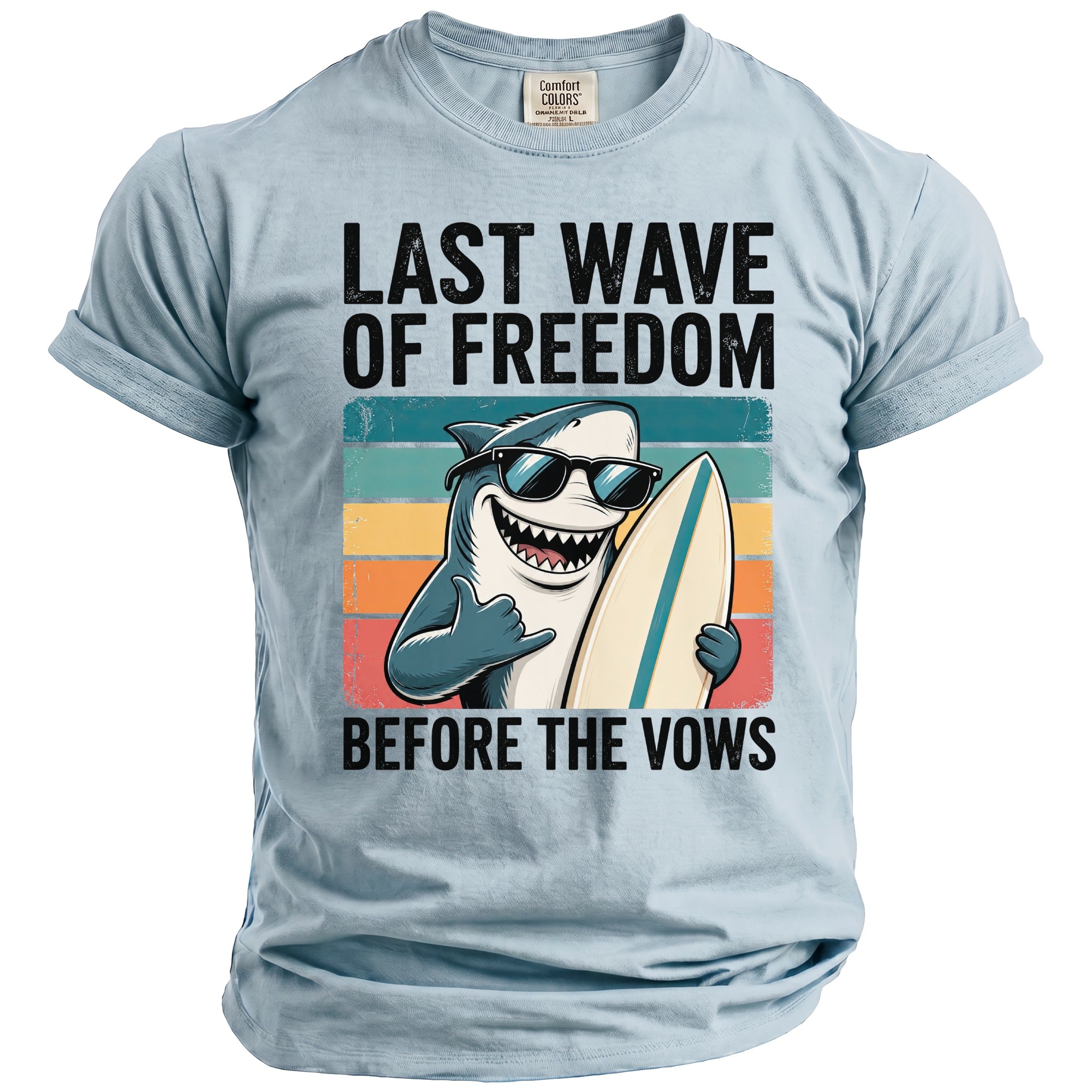Light blue t-shirt with a graphic of a shark in sunglasses holding a surfboard.