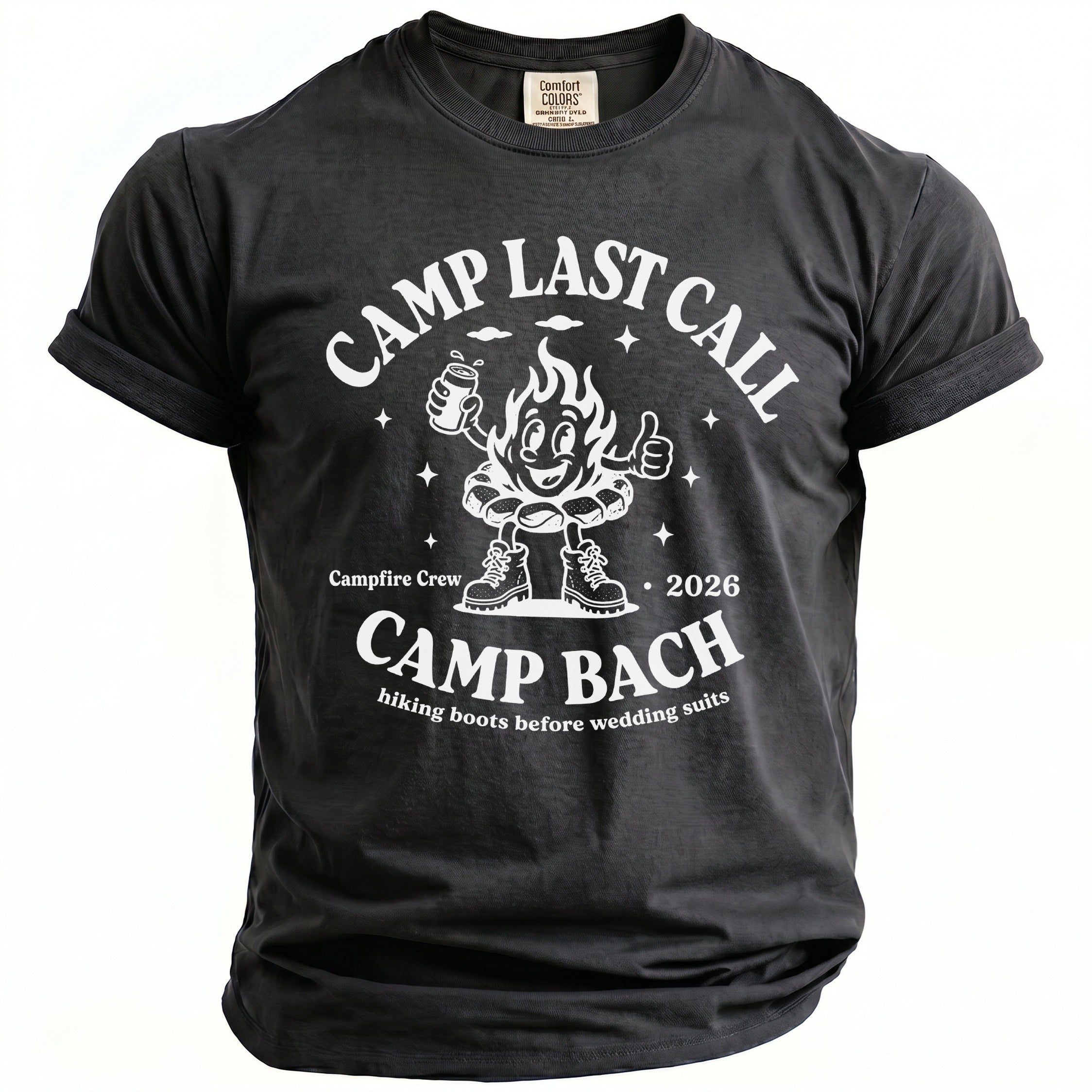 Black t-shirt featuring a white graphic of a smiling campfire character, camping gear, and text reading CAMP LAST CALL CAMP BACH.