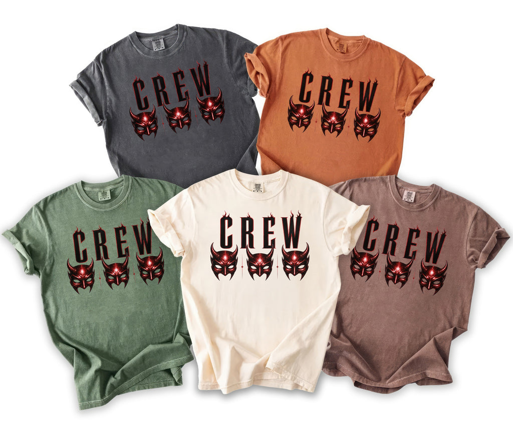 Five t-shirts in different colors featuring the word "CREW" with demonic masks.