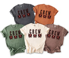 Five t-shirts in different colors featuring the word "CREW" with demonic masks.