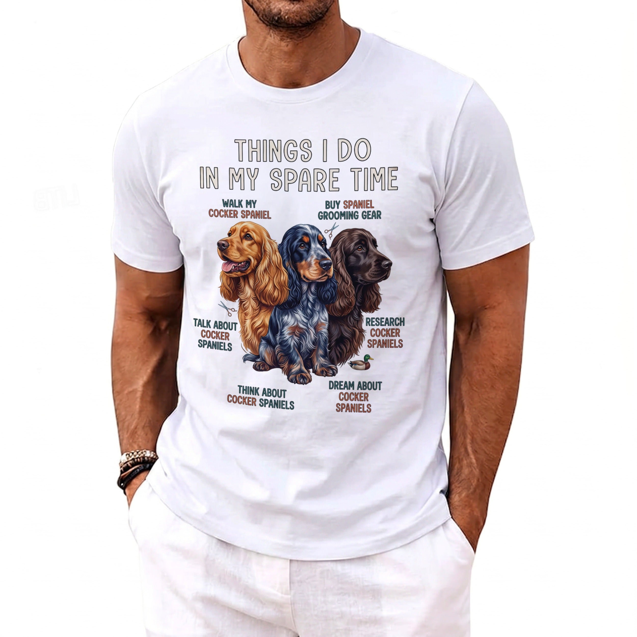White t-shirt featuring three cocker spaniels and text about spare time activities.