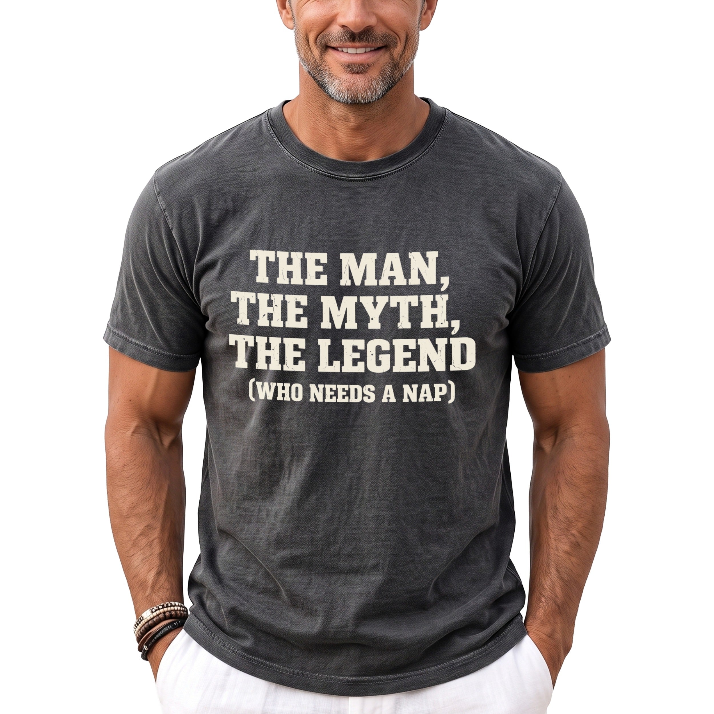 Man wearing dark grey t-shirt with white text: The Man, The Myth, The Legend (Who Needs a Nap).