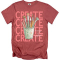 Red t-shirt with "CREATE" text and a cup of art supplies.