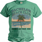 Green t-shirt with "Bachelor Beach Club Groom's Last Wave 2026" text and retro beach graphic.