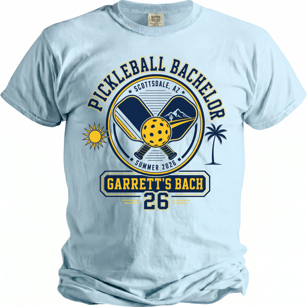 Light blue t-shirt with "Pickleball Bachelor" design and "Garrett's Bach 26" in yellow and navy.