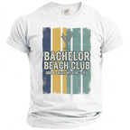 White t-shirt with "Bachelor Beach Club Groom's Beach Weekend - 2026" text.