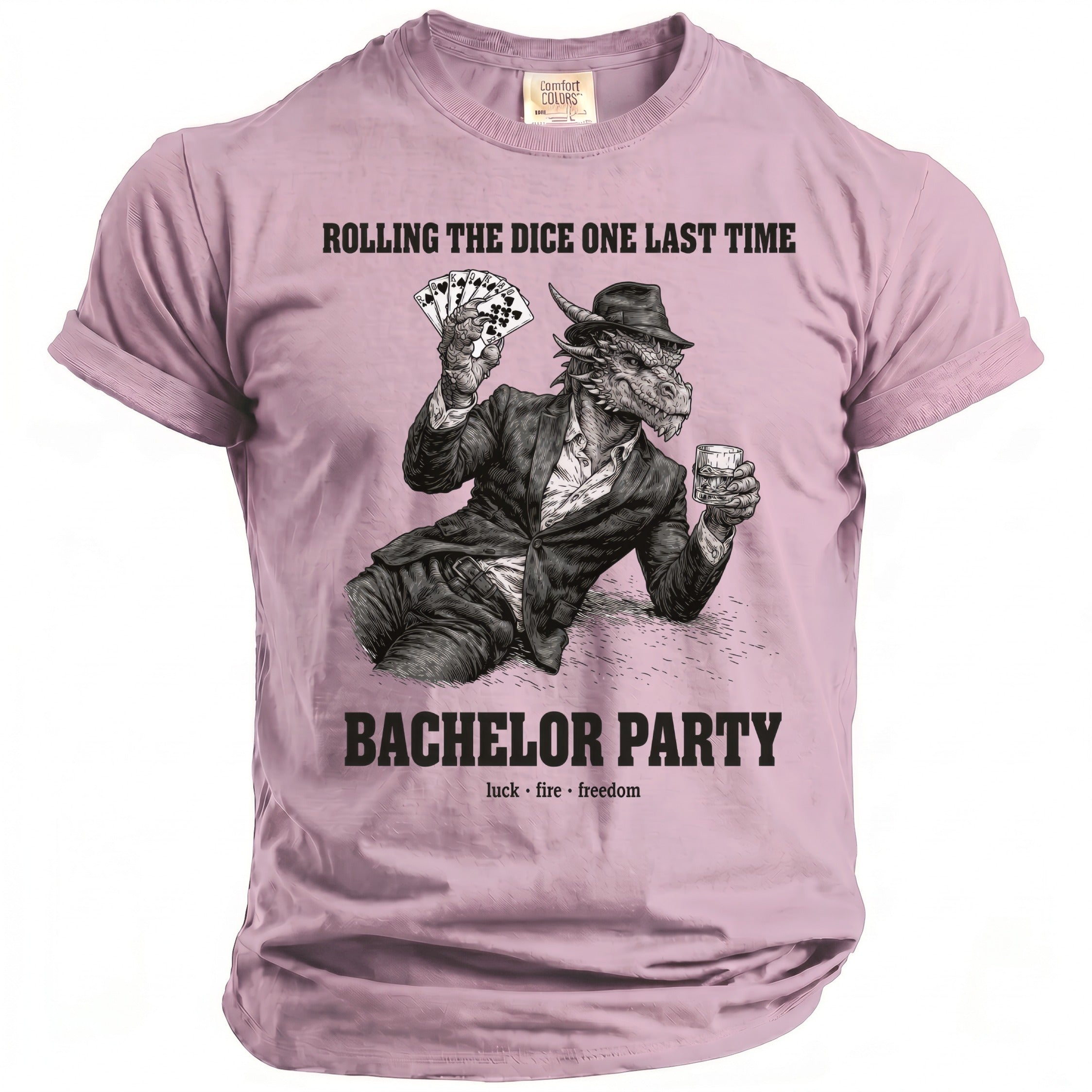 Pink t-shirt with a dragon in a suit holding cards and a drink, text reads "Rolling the dice one last time, Bachelor Party".