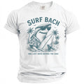 White t-shirt with a drawing of a shark in sunglasses holding a surfboard, with text "SURF BACH".
