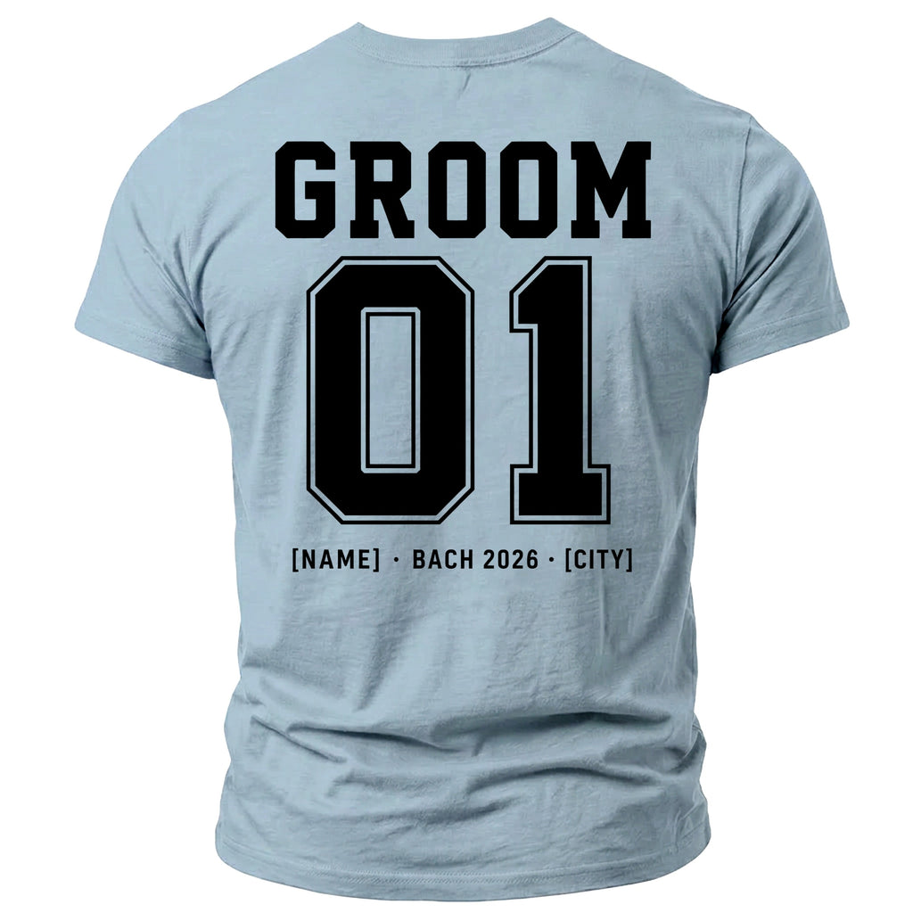 Pale blue t-shirt with black text: GROOM, 01, [NAME] • BACH 2026 • [CITY].