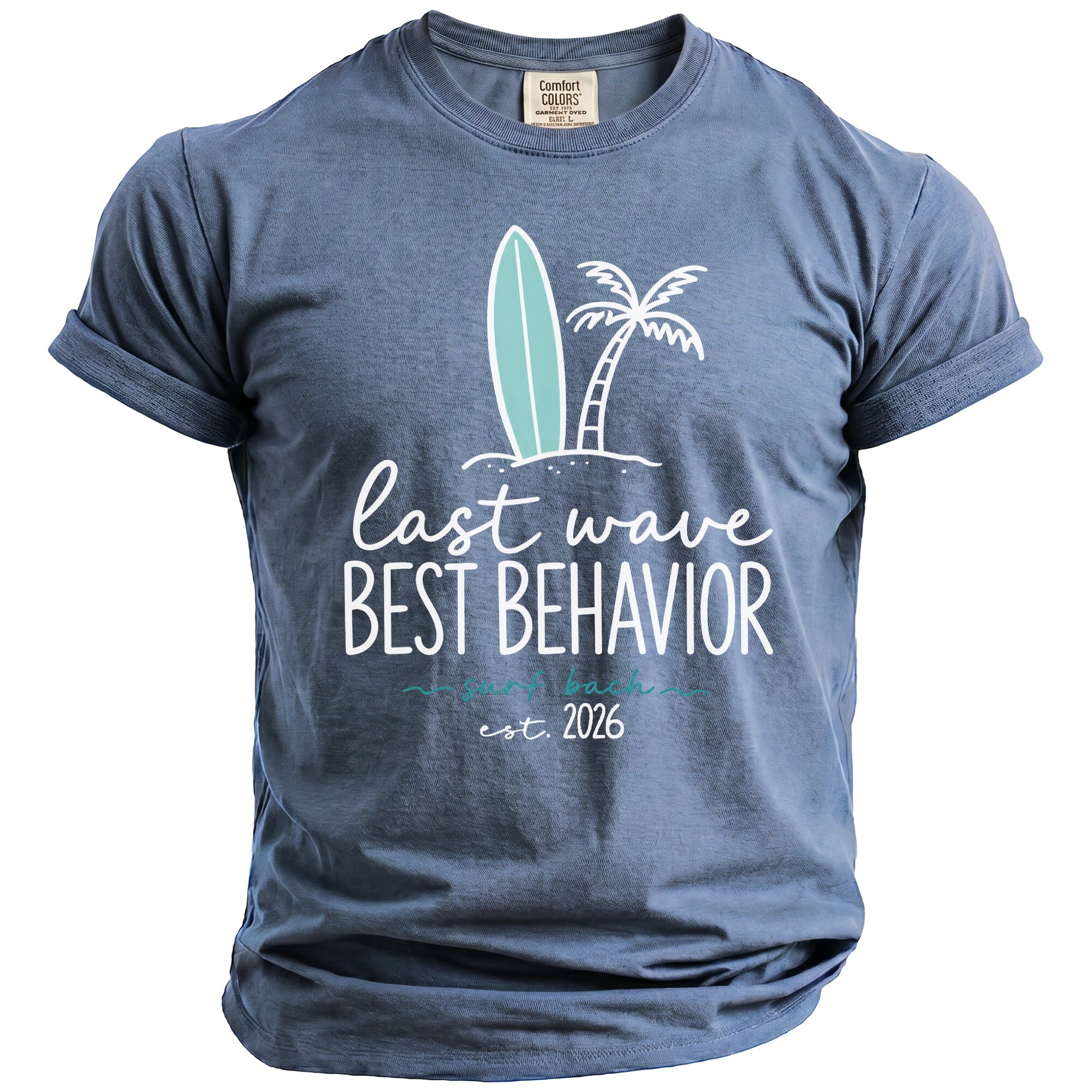 Blue t-shirt with graphic of surfboard, palm tree, and text "last wave BEST BEHAVIOR est. 2026".