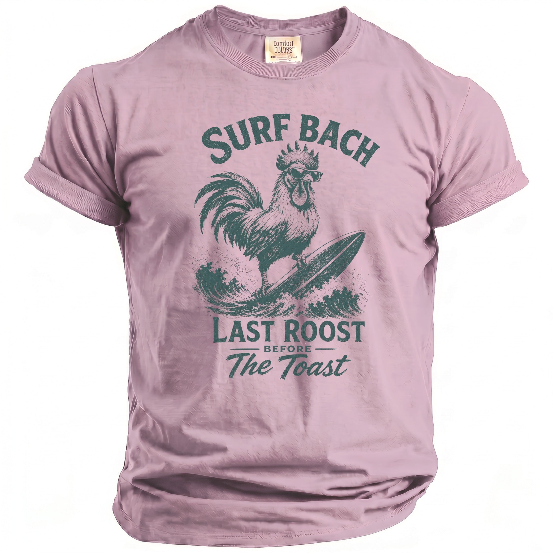 Pink t-shirt with a dark green graphic of a rooster surfing and text "Surf Bach Last Roost Before The Toast".