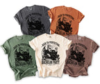 Five t-shirts in different colors featuring a dragon in a suit with whiskey and text "Bachelor Party".
