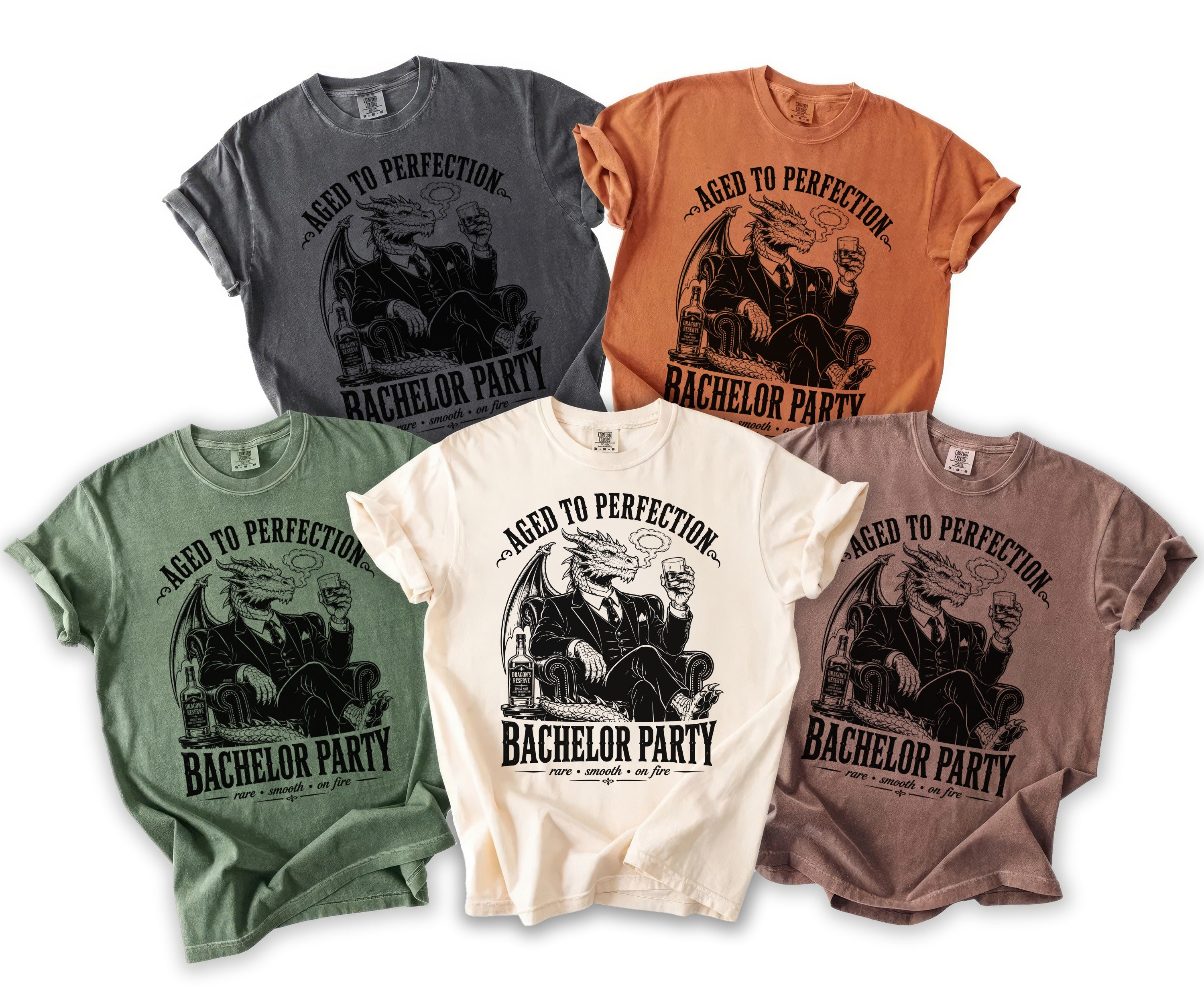 Five t-shirts in different colors featuring a dragon in a suit with whiskey and text "Bachelor Party".