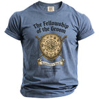 Blue t-shirt with "The Fellowship of the Groom" text and shield design.