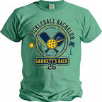 Green t-shirt with "Pickleball Bachelor Garrett's Bach 26 Summer 2026" graphic.
